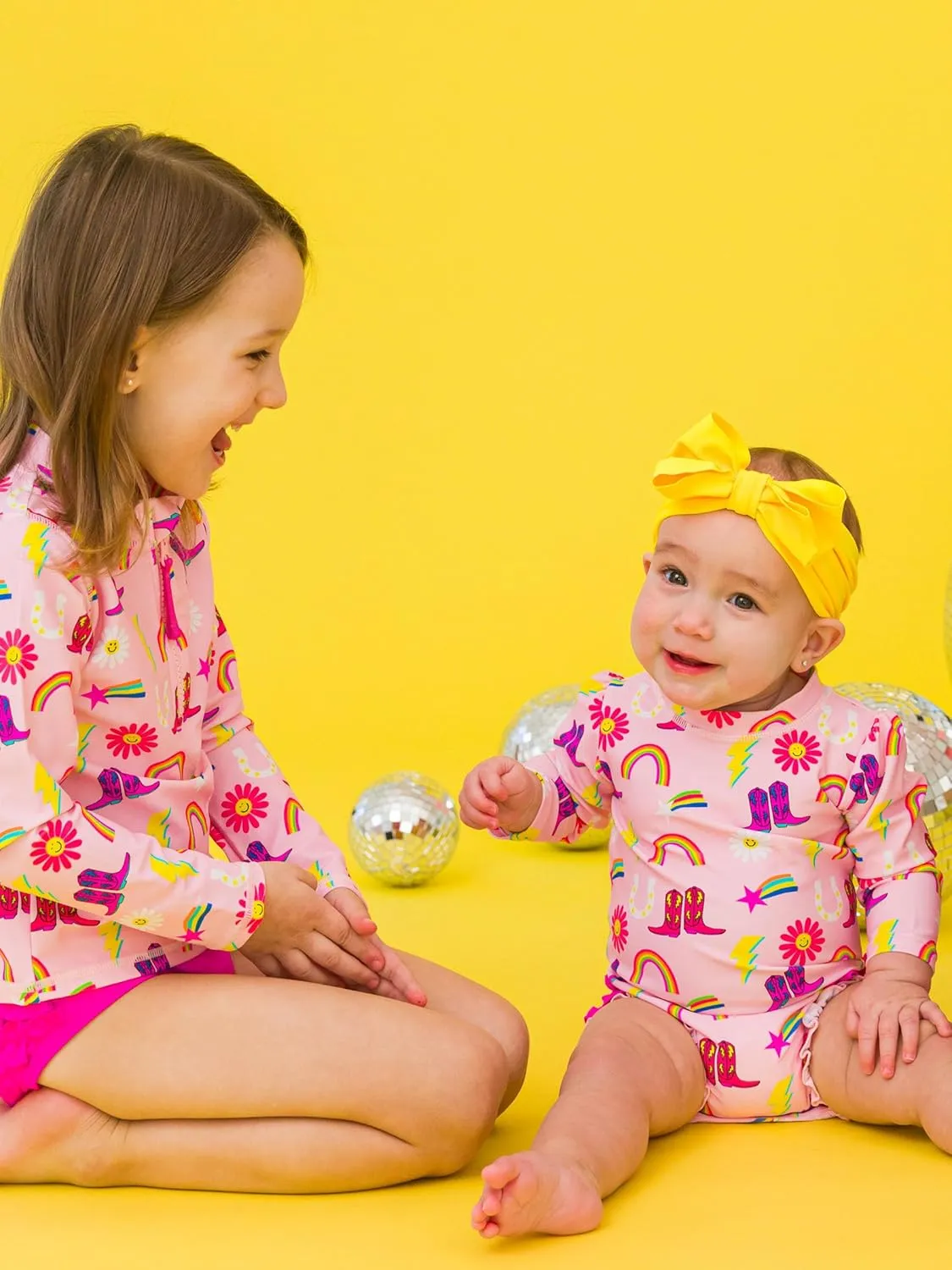 RuffleButts Baby Girls UPF 50  Sun Protection Novelty Print Long Sleeve One Piece Rash Guard Swimsuit with Zipper